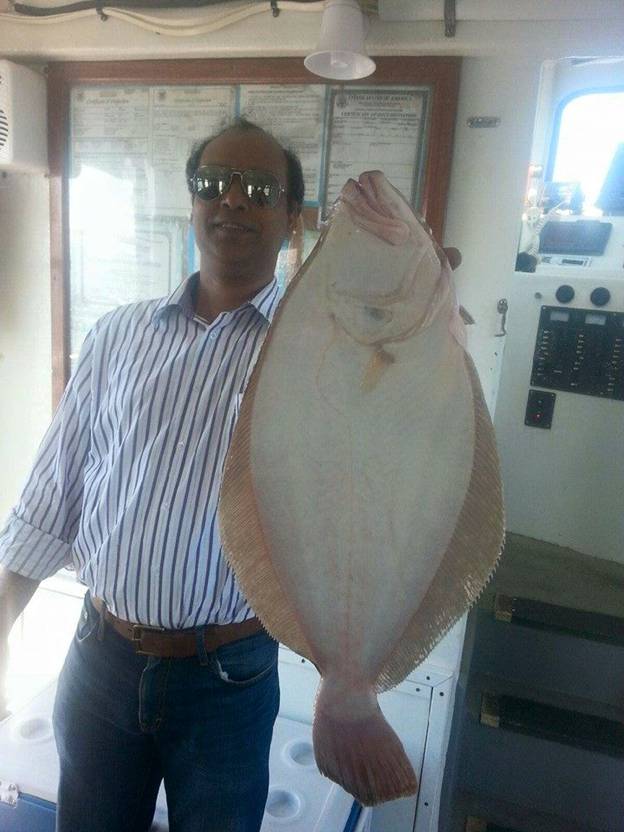 man holding big flounder