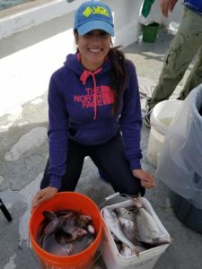girl-with-hat-and-two-buckets-of-fish